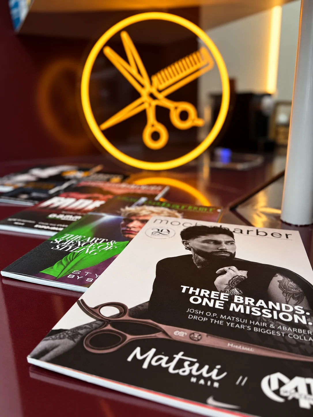 Grooming magazines and our golden scissors-and-comb neon sign