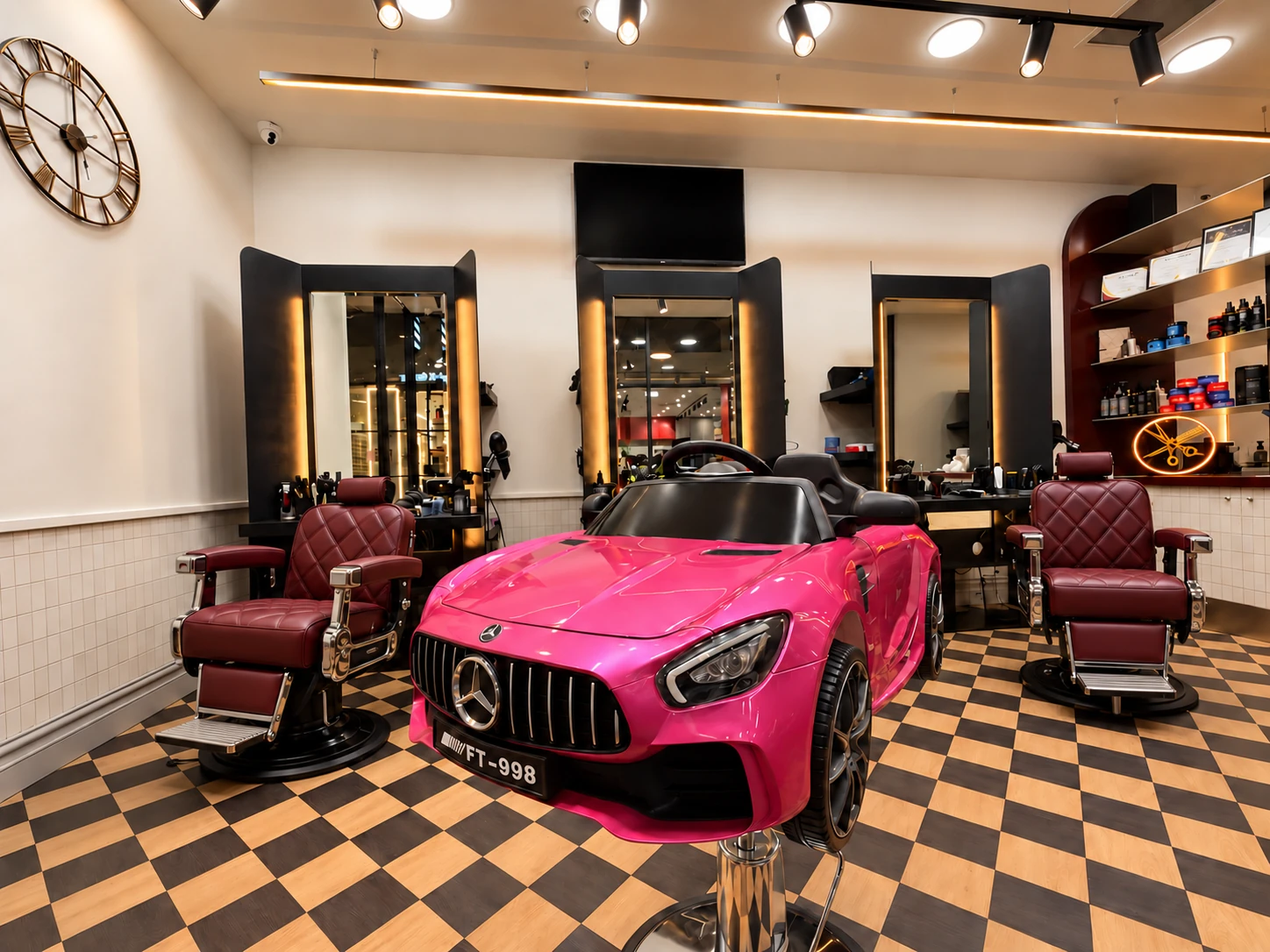 Pink kids’ car chair with premium burgundy barber seats at Barber Embassy Granville